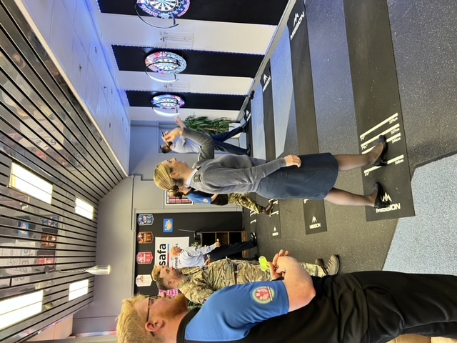 Photo - The Station Commander, Group Captain Claire O'Grady throwing a dart at a dartboard